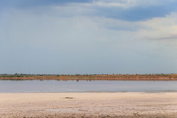 Dark storm clouds over a salt lake before a rain