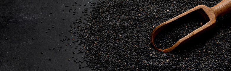 Black sesame seed on black background. Organic food concept.