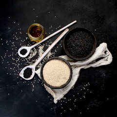 Black and white sesame seed on black background. Organic food concept