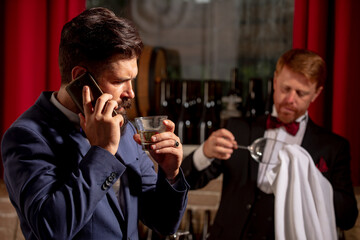 Gentlemans beverage. Whiskey in glass. Bartending concept. Barman at counter. Hipster in bar.