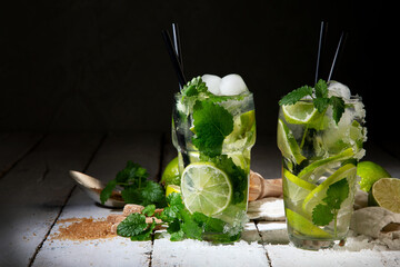 Fresh made Mojito cocktail on dark background. Summer drinks concept.