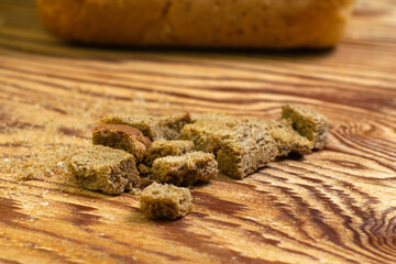 rye crackers on a wooden table in the background in a blur a loaf of bread