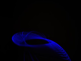 Closeup of Neon blue Spirograph geometric abstract pattern flowing in a isolated black background . Made using Long exposure technique, Light painting. Pendulum pattern. © sanju's view
