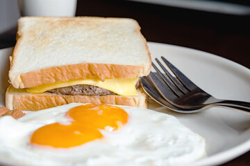 The Breakfast on the table are eggs and hamburger.