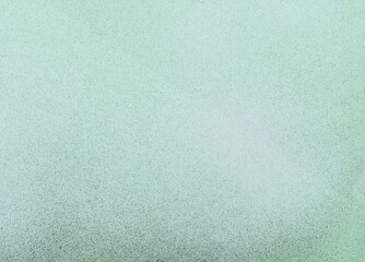 black and white spray paint on a soft green colored paper background