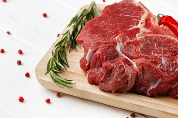 Beef tenderloin on wooden board on wooden table