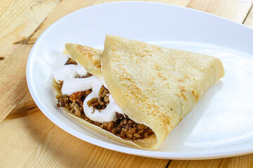 Pancake with minced meat and sauce