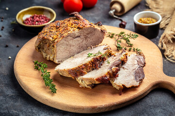 Big Piece of Slow Cooked Oven-Barbecued Pulled Pork shoulder with thyme herb mustard on a cutting board