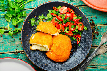Chicken kiev cutlet with salad
