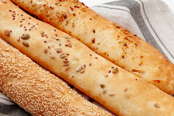 Fresh baguette bread on white wooden table