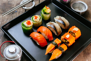 Sushi Set and sushi rolls served on wood table