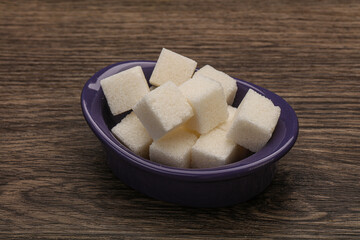 Refined white sugar cubs in the bowl
