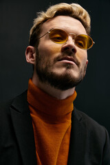portrait of a confident young man fashionable clothing jacket orange sweater close-up cropped view