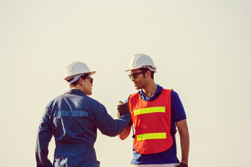Engineer and worker soul brother handshake, thumb clasp handshake or homie handshake, Happy foreman team join hands together, Success and Teamwork concepts
