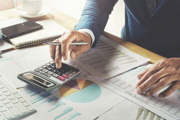 businessman working in office using calculator. finanace and accounting concept