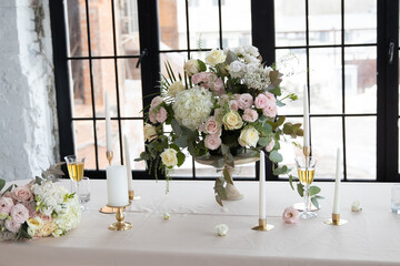 Wedding table with bouquet of flowers and champagne