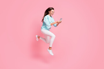 Full length profile photo of attractive blogger use phone in motion run fast write post isolated on...
