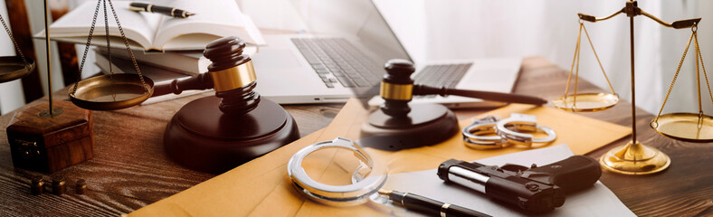 Justice and law concept.Male judge in a courtroom with the gavel, working with, computer and...