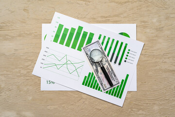 Financial paper with charts and diagrams on gray table