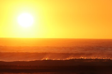 Sunset over the agitated ocean, on the skeleton coast in southern Namibia.