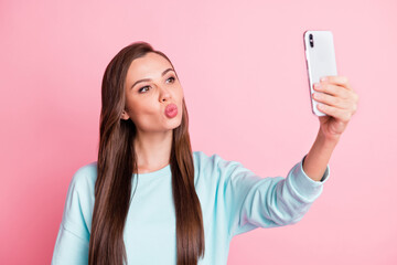 Photo of beautiful flirty young woman take photo selfie send air kiss isolated on pastel pink color background