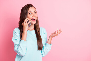 Photo of brown haired young lady talk smartphone look copyspace wear blue jumper news isolated on shine pink color background