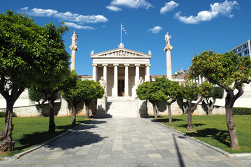 Fototapeta premium Beautiful neoclassic Academy of Athens public landmark building with beautiful spring clouds and deep blue sky, Athens historic centre, Attica, Greece