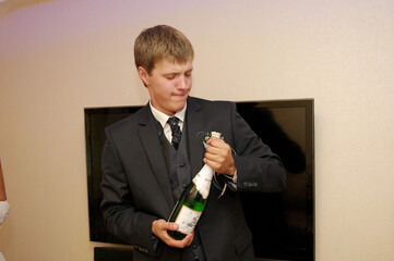 Beautiful young man with a bottle of chamapgne