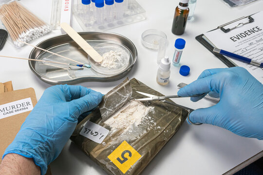 Specialised police open bundle of drugs in crime lab, conceptual image