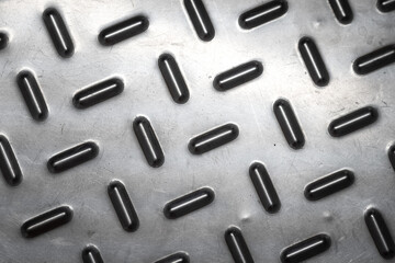 Metallic anti-slipping or falling floor material with lighting reflect on it surface, top view. Background and texture object pattern photo.	
