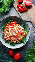 Healthy food, Vegetable salad, Tomato, greens and kale on dark background