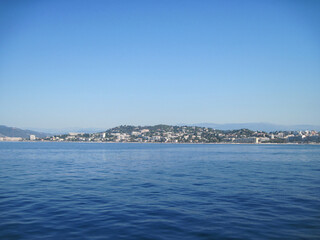 Scenic panoramic landscape of Cannes town of the sea country in the morning. Beautiful view of the sea and mountains. Seascape with coast of island. Skyline view from yacht in the sea.