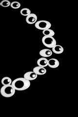 A circle of toy eyes on a black background