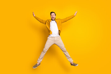 Fototapeta na wymiar Full length photo of pretty sweet gentleman dressed casual outfit smiling jumping high like star isolated yellow color background