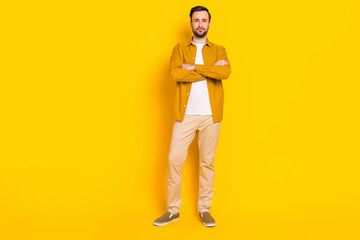 Full length photo of sweet confident young gentleman dressed casual outfit standing hands folded isolated yellow color background