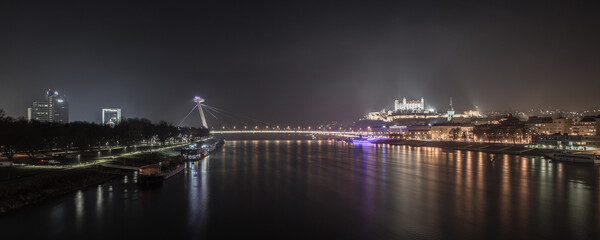 Night view of Bratislava, historical  castle and  Danube river, UFO restaurant and the bridge; Bratislava at night, Slovakia