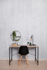 Stylish workplace in office or home - copy space over concrete wall