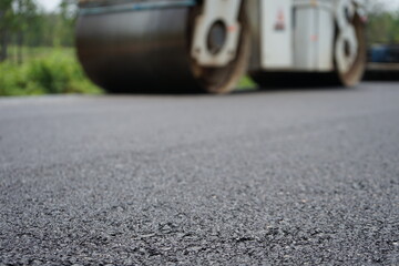 The image is blurred in the construction of asphalt road.