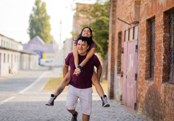 Young happy couple spending time on the street.