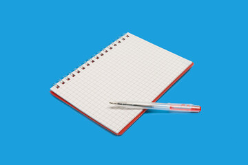 spiral notebook with a pen on a blue background