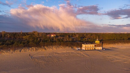 Beautiful beach with lifeguards house and amazing cloud at Baltic Sea, Gdansk, Poland.