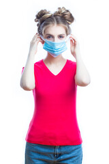 Medical Ideas. Friendly Caucasian Girl Demonstrating Surgical Mask Facial Application Step By Step Against White Background.