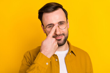 Photo of young handsome man happy positive smile fix correct eyeglasses isolated over yellow color background