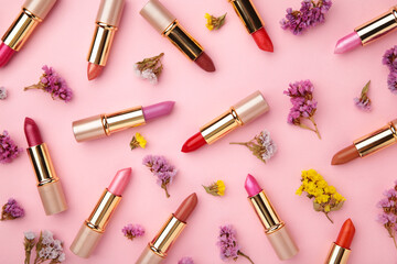 Lipstick with beautiful flowers on pink background