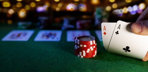 play poker in casino. pocket aces and chips. copy space