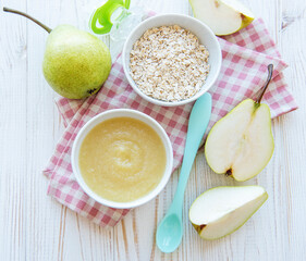 Bowl with fruit baby food and pears