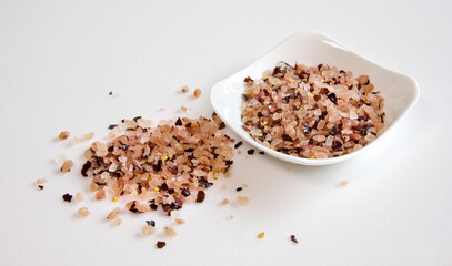 himalaya pink salt with red pepper on white plate.