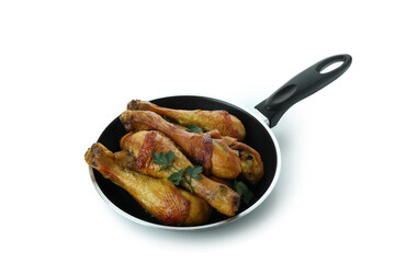 Pan of roast chicken drumsticks isolated on white background