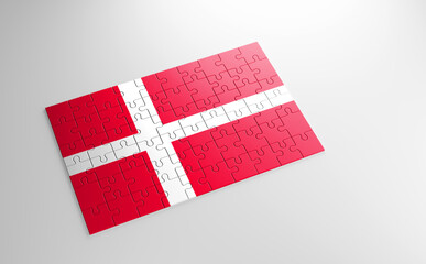 Fototapeta na wymiar A jigsaw puzzle with a print of the flag of Denmark, pieces of the puzzle isolated on white background. Fulfillment and perfection concept. Symbol of national integrity. 3D illustration.