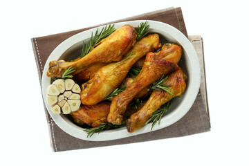 Tray of roast chicken drumsticks isolated on white background